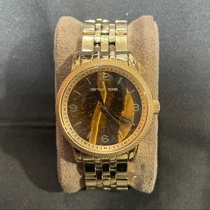 Gold Micheal Kors watch with brown cat eye face